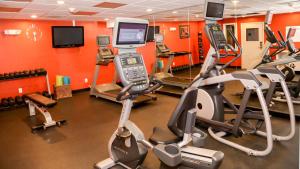 a gym with several cardio machines and a television at Holiday Inn Express & Suites Colorado Springs North, an IHG Hotel in Colorado Springs