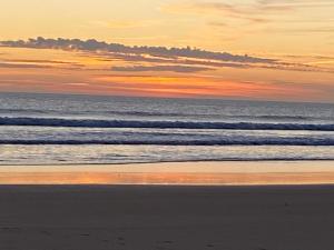 a person walking on the beach at sunset at Albur Village B - Gerbera in Alvor