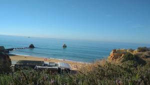 a beach with people on the sand and the ocean at Albur Village B - Gerbera in Alvor