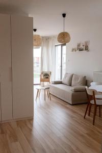 a living room with a couch and a table at Eco apartament Nałęczów in Nałęczów