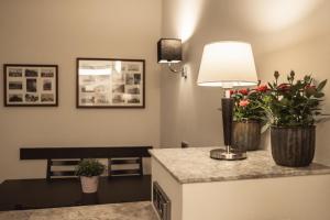 a room with a lamp and flowers on a counter at athome IHR Apartment in Chemnitz