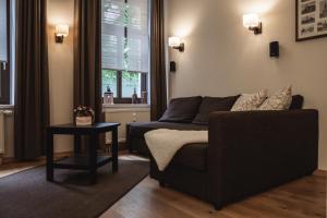 a living room with a couch and a table at athome IHR Apartment in Chemnitz