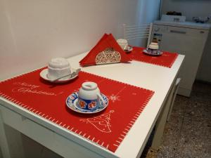 a table with red napkins and china on it at L'Angolo Di San Pietro in Rome