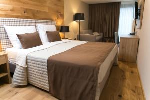 a bedroom with a large bed in a hotel room at Korona, Resort & Entertainment in Kranjska Gora