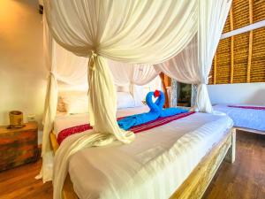 Letto o letti in una camera di Namaste Bungalows