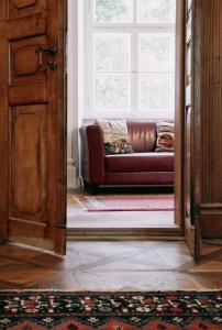 a living room with a couch and a window at Schloss Burgellern in Scheßlitz