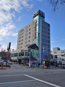 a hotel building with a sign on top of it at Metro Pol Tourist Hotel in Pyeongtaek