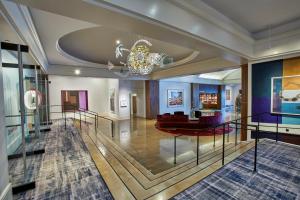 a lobby with a chandelier and a living room at Saint Kate - The Arts Hotel in Milwaukee