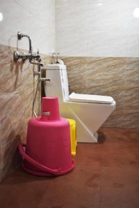 a bathroom with a toilet and a sink at Viraz Valley in Gokarna