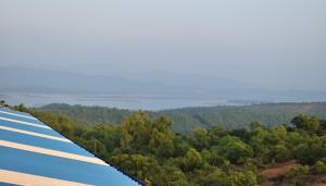 a view from the top of a building with trees and water at Viraz Valley in Gokarna