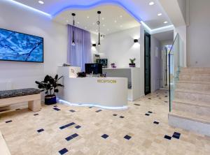 a reception room with a blue ceiling and stairs at Diamond Rain Boutique Hotel in Sarajevo