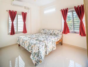 a bedroom with a bed and two windows at Castle JP Service Apartments in Bangalore