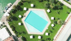 an overhead view of a large swimming pool in a park at Porto Romano - The Marina Resort in Fiumicino