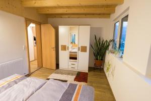 1 dormitorio con cama y pasillo con espejo en Appartement Christiane, en Bludenz