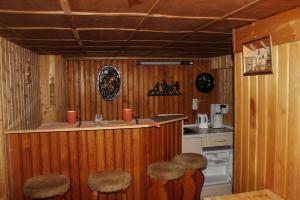 a kitchen with a counter and stools in a room at Ferienhaus Wittmann in Kurort Oberwiesenthal