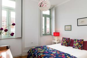 um quarto com uma cama e duas janelas em Ilda's Home - Big Families & Groups no Porto