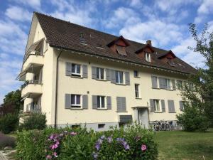 a large white building with a brown roof at Ferienwohnung in Bern in Bern