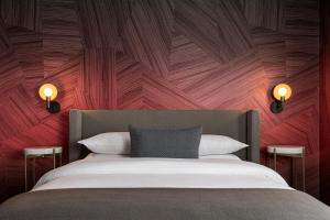 a bedroom with a bed with a wooden wall at  Liz by Black Swan - DC Executive Flat in Washington