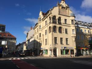 un grand bâtiment blanc au coin d'une rue dans l'établissement Palais Gutenberg la Ville, à Klagenfurt am Wörthersee