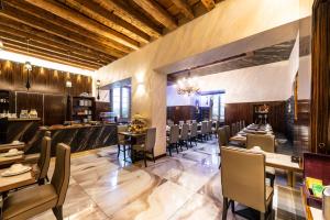 a restaurant with tables and chairs and a bar at Hotel Abbazia in Venice