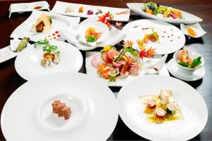 a table with white plates of food on it at Kajitsu no Mori in Ichinoseki