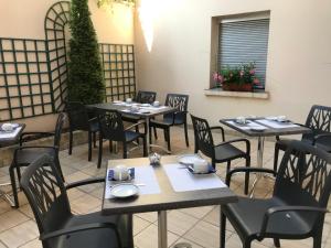 een restaurant met tafels en stoelen in een kamer bij Hôtel du Lion in Vesoul