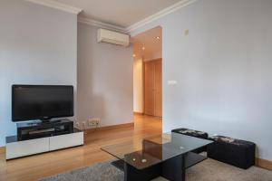 sala de estar con TV y mesa en LovelyStay - Modern apartment in Anjos, en Lisboa