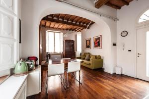 a living room with a table and a couch at The Galileo Apartment in Pisa