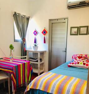 a bedroom with a bed and a table and a window at Cozy Little Apartment in Sayulita