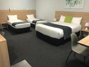 A bed or beds in a room at Frewville Motor Inn