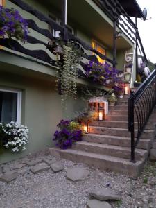 uma casa com flores roxas nas escadas em Agroturystyka Tylmanowa em Tylmanowa