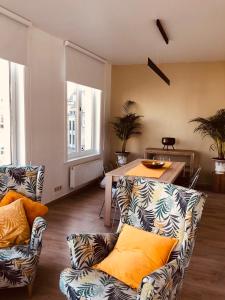 a living room with two couches and a table at Evelyns Corner Duplex in Ghent