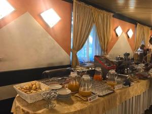 a table filled with food and a basket of food at Hotel Atlantic in Arona