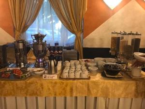 a table filled with food and appliances on top at Hotel Atlantic in Arona