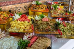 un buffet de différents types de nourriture dans des plats en verre dans l'établissement Club Pink Palace Hotel, à Ölüdeniz