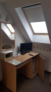 an office with a desk with a computer in an attic at The Corner House Panzió in Tata