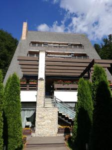 a building with a bunch of plants in front of it at Casa Freya in Buşteni