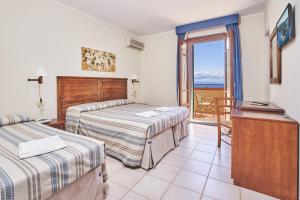 A bed or beds in a room at Hotel Villa Rodriguez