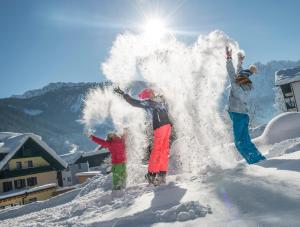 a group of people standing in the snow at Hotel Sommerhof in Gosau