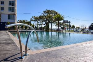 a swimming pool with a metal railing next to a building at Hotel Legends in Biloxi