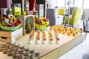 um buffet de frutas e bebidas numa mesa em Holiday Inn Amsterdam - Arena Towers, an IHG Hotel em Amesterdão