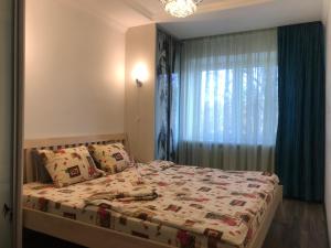 a bedroom with a bed and a window at Fine Apartment in Jelgava