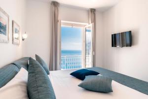 a bedroom with a bed with a view of the ocean at Casa Dolce Casa in Ravello