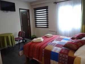 a bedroom with a bed with two towels on it at Hostal Bivouac in La Paz