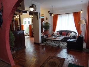 a living room with a couch and a table at Hostal Bivouac in La Paz