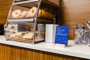 een plank met donuts en een bord erop bij Holiday Inn Express & Suites - West Edmonton-Mall Area, an IHG Hotel in Edmonton