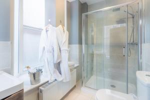 a bathroom with a glass shower and a toilet at Shipquay Boutique Hotel in Derry Londonderry