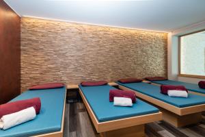 a room with four tables with red and white pillows at Hotel & Gasthof Richard Held in Regensburg