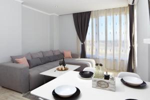 a living room with a couch and a table at Niko's Sea View Apartments Deluxe in Nesebar