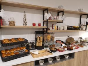 a kitchen with bread and other food on a counter at ATOLON PARK HOTEL in Brumath